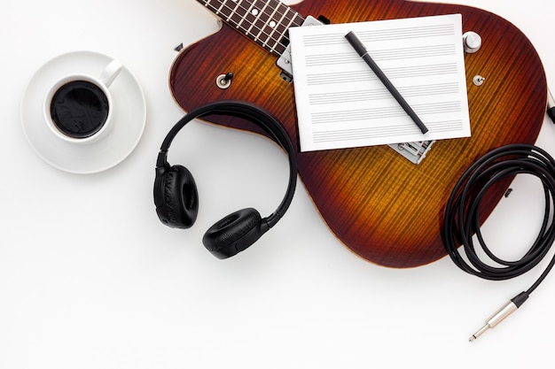 Musician work set with guitar, note and headphones