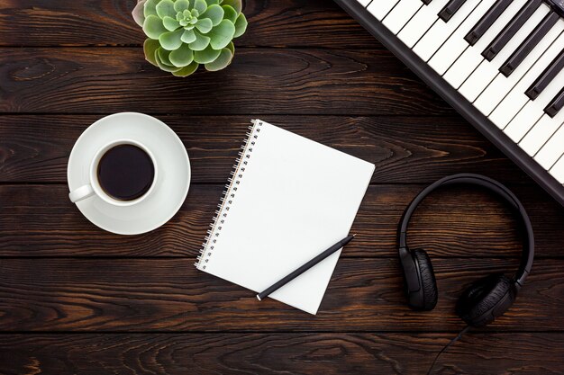 Musician work set with synthesizer, note and headphones