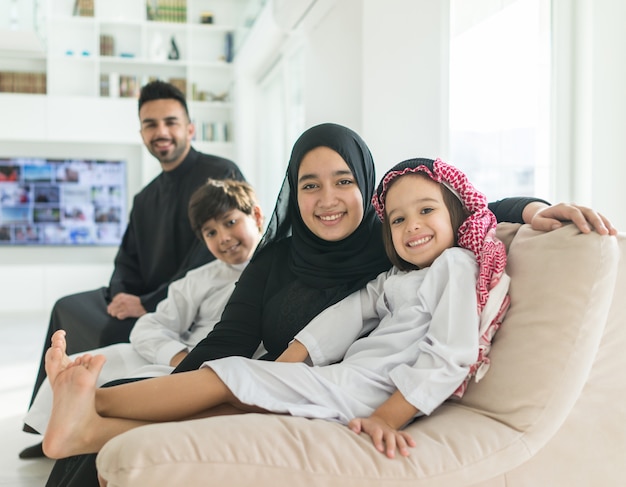 Muslim Arabian family on sofa at home