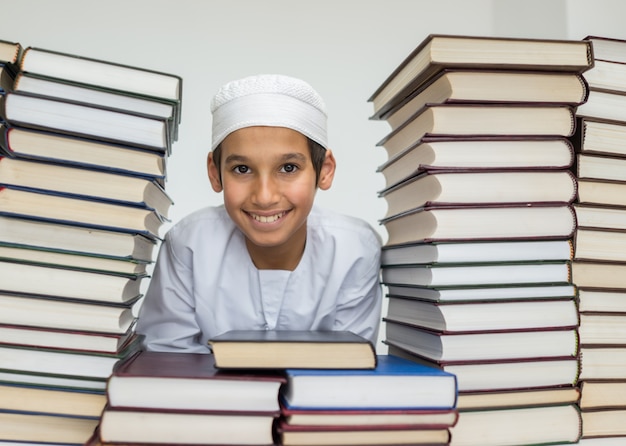 Muslim Arabic kid in library with books