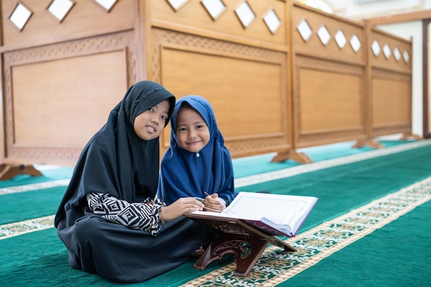 Muslim asian kid reading Quran