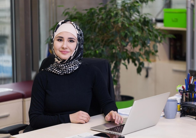 Muslim asian woman working in office with laptop