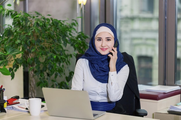 Muslim asian woman working in office with laptop