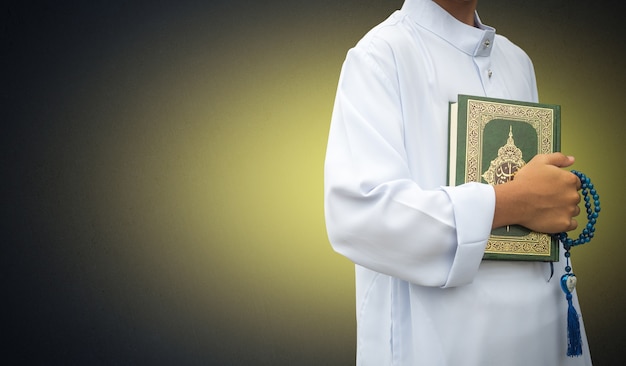 muslim boy holding holy Quran