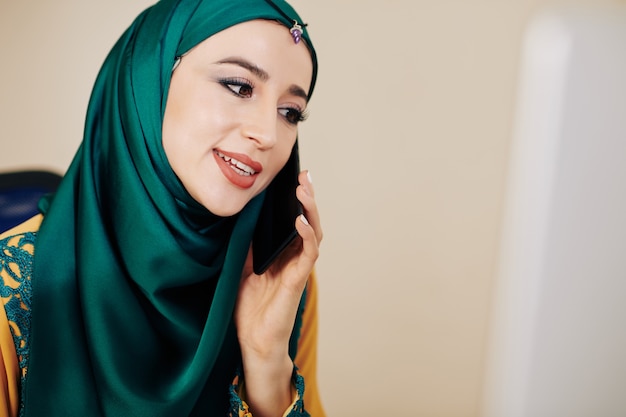 Muslim businesswoman making phone call