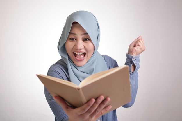 Muslim Businesswoman Reading Book Surprised