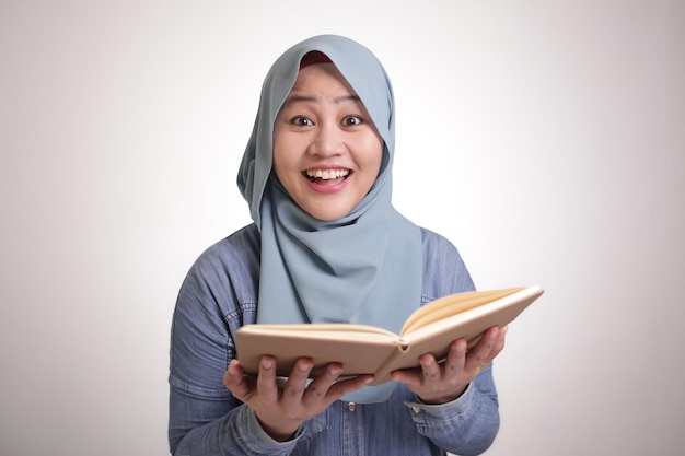 Muslim Businesswoman Reading Book Surprised