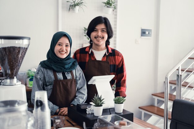 Muslim cafe owner with partner