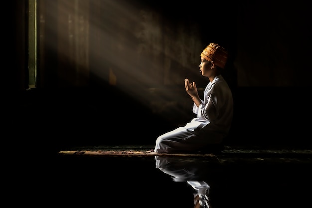 Muslim children kid men wearing white shirts Doing prayer reading book