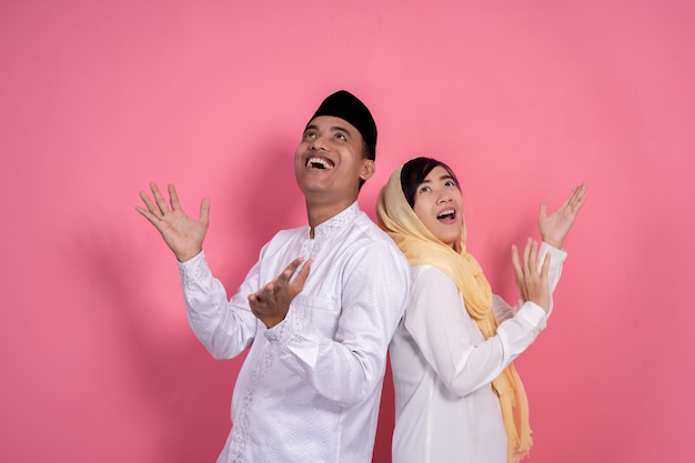 Muslim couple looking up copyspace