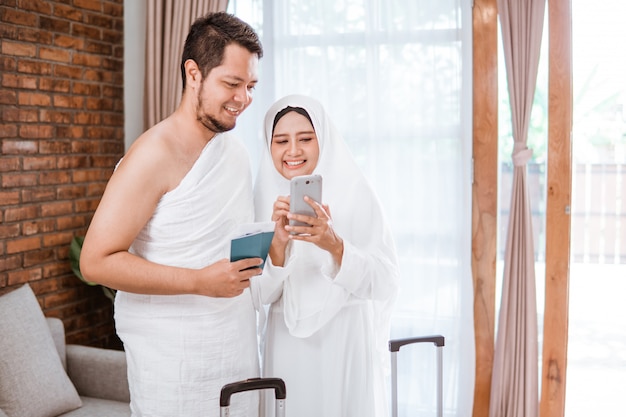 Muslim couple making a phone call while umrah and hajj