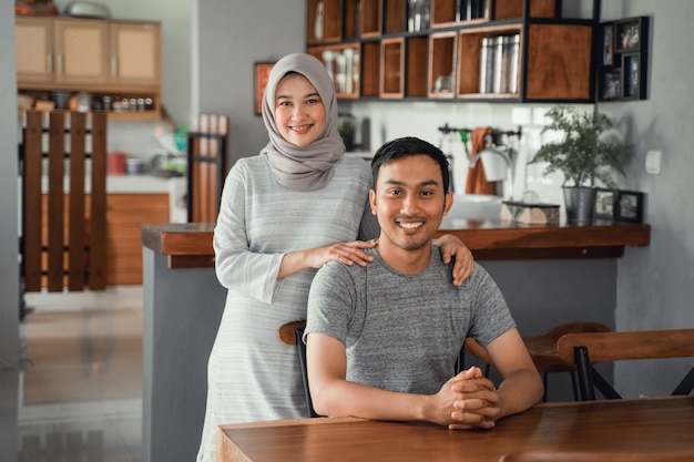 Muslim couple sitting in dining room together