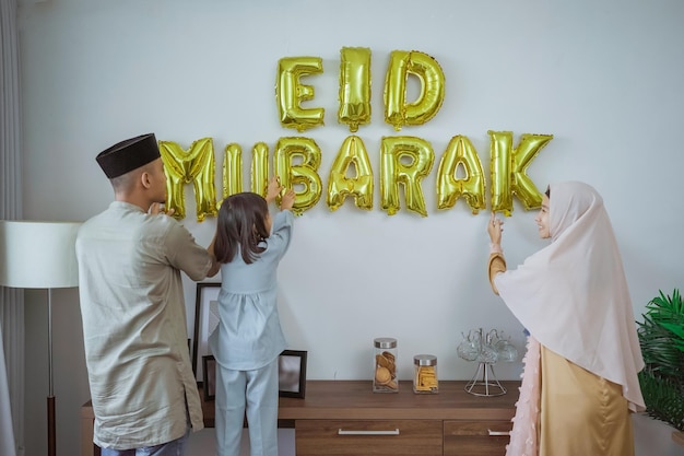 Muslim decorating eid mubarak letter made of baloon