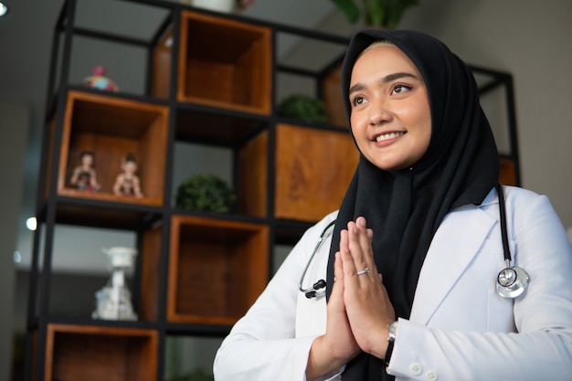 Muslim doctor working at her clinic