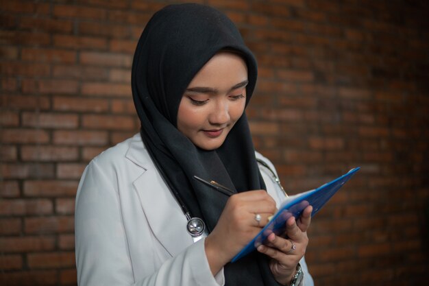 Muslim doctor working at her clinic