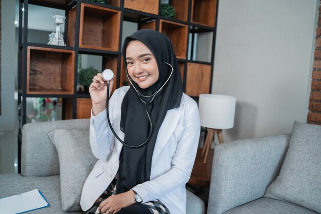 Muslim doctor working at her clinic