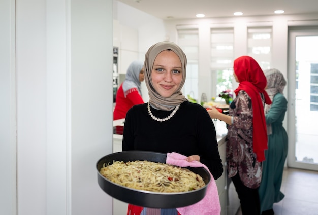 Muslim family and friends gathering together at home for eating dinner. High quality photo