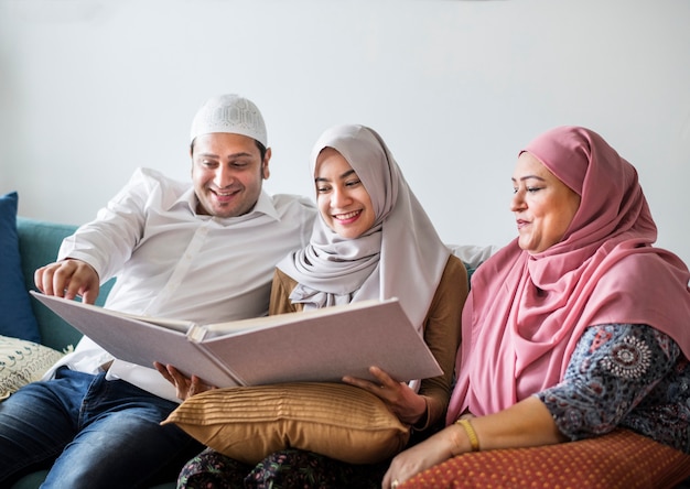 Muslim family looking in a photo album