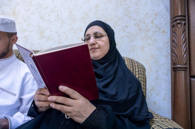 Muslim family reading a book while drinking coffee