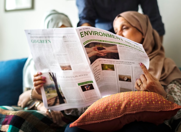 Muslim family reading the news