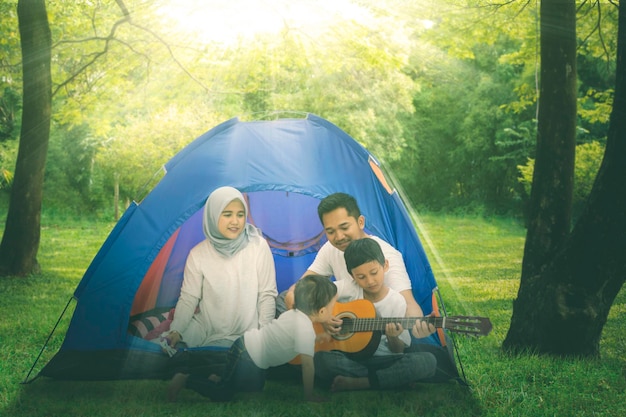 Muslim family singing with a guitar in the tent