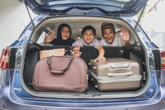 Muslim family travel by car during eid mubarak celebration. asian people go back to their hometown