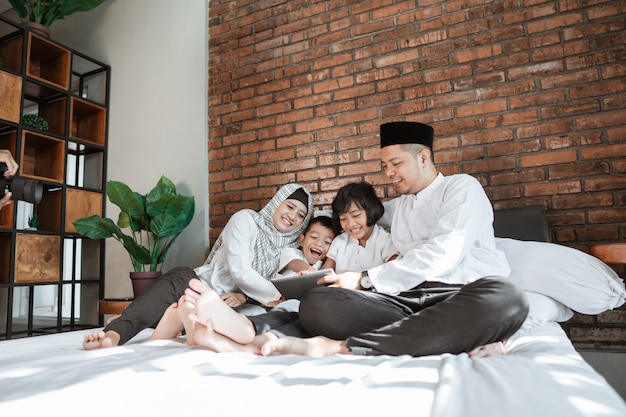 Muslim family using tablet together