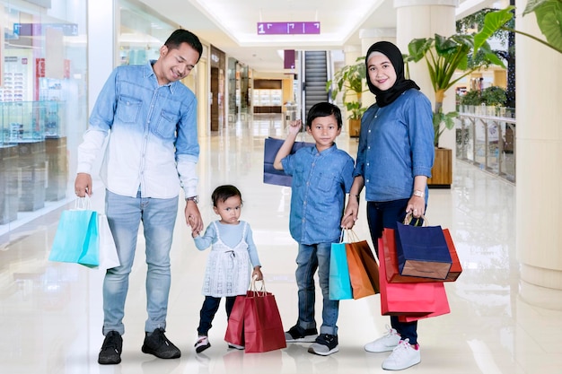 Muslim family with shopping bags in the mall