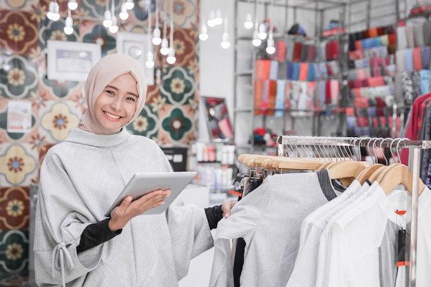 Muslim fashion boutique owner with tablet