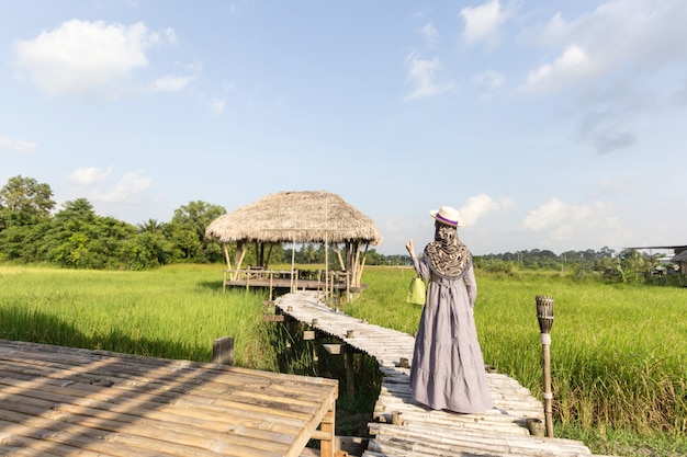 Muslim female traveler taking photo with smart phone of beautiful field