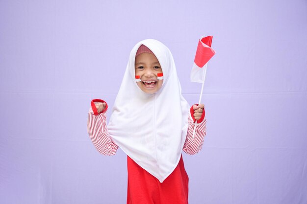 Muslim girl celebrate indonesian independence day on 17 august expression of winning the race