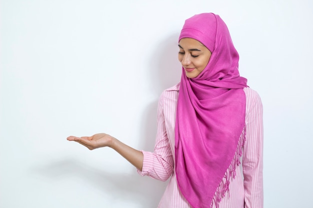 Muslim girl in hijab shows her hands copy space