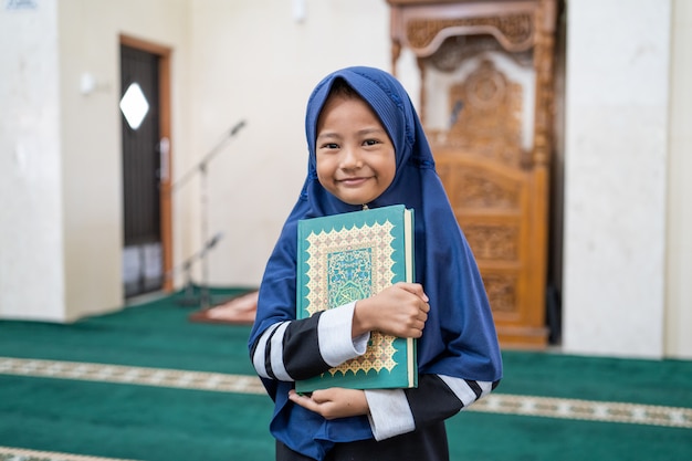 Muslim girl kid holding Quran