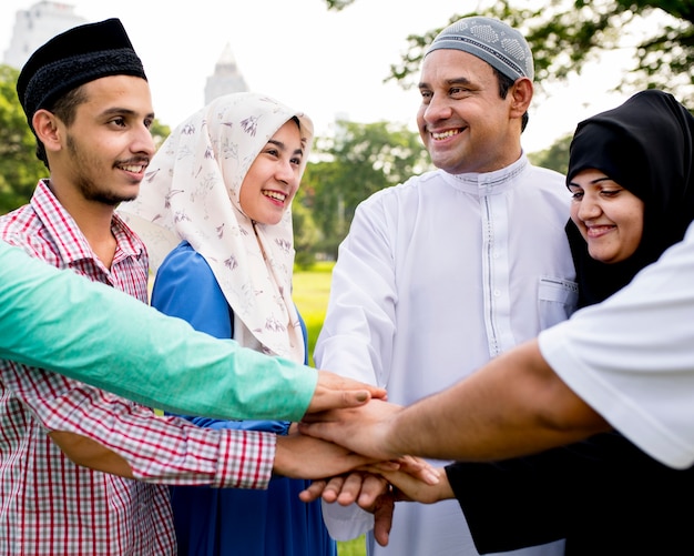 Muslim group of friends stacking hands