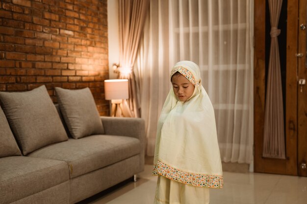 Muslim kid praying by herself