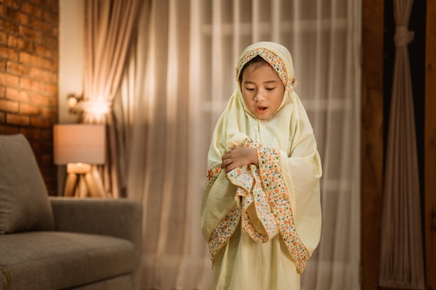 Muslim kid praying by herself