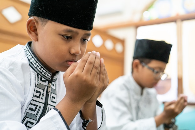 Muslim kid praying to God