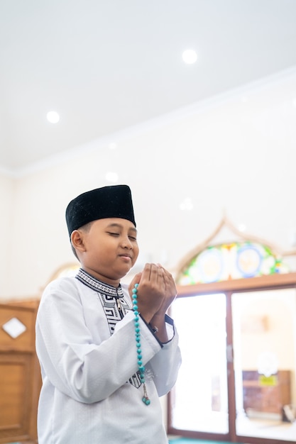 Muslim kid praying to God