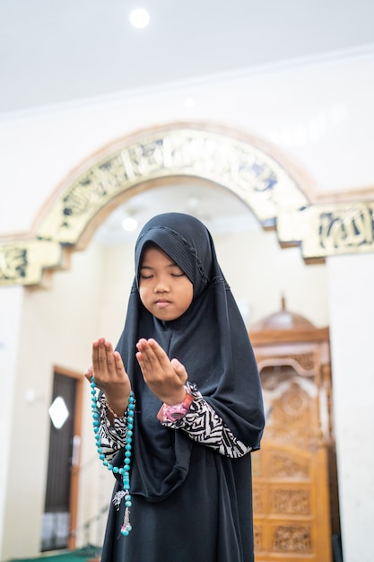 Muslim kid praying to God