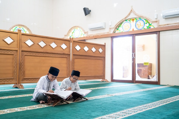 Muslim kid reading Quran