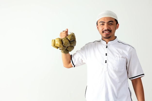 Muslim Male Holding Ready to Eat Ketupat Rice Cake with Diamond Shape