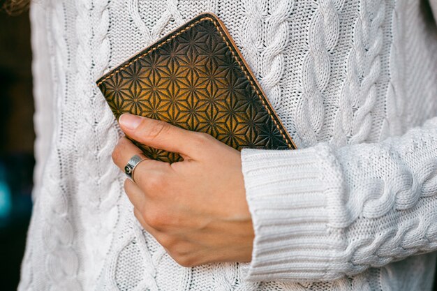 Muslim man hands holding the koran in the mosque.