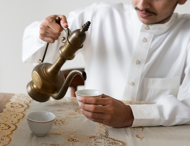 Muslim man having a cup of tea