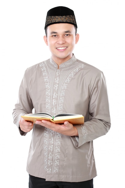 Muslim man holding quran