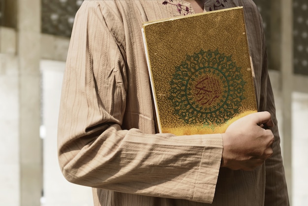 Muslim man holding quran