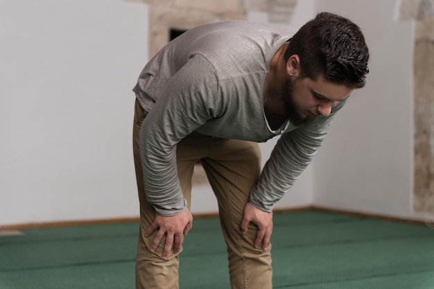 muslim man is praying in the mosque