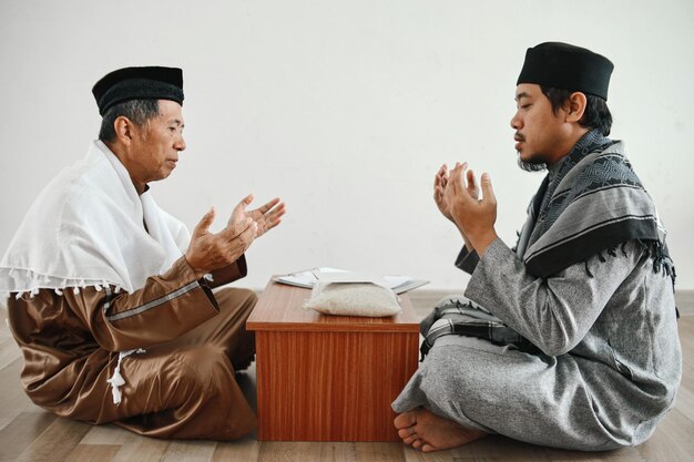 Muslim man praying together after giving and receiving donation or zakat at mosque islamic zakat co