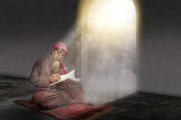 Muslim man with a beard wearing keffiyeh with agal sitting and reading the Quran