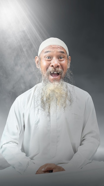 Muslim man with a beard wearing a white cap