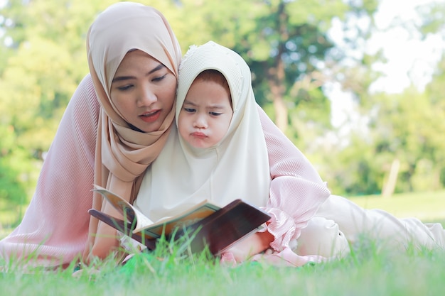 Muslim mother and daughter enjoy relaxing in the park.